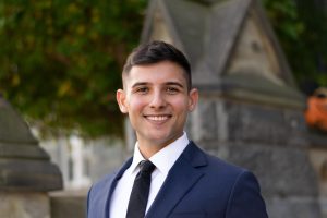 Arthur Milhomens portrait while in a suit and tie