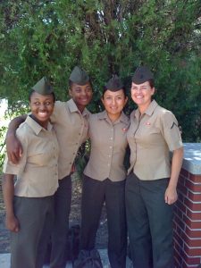 A group of four women in Marine uniforms