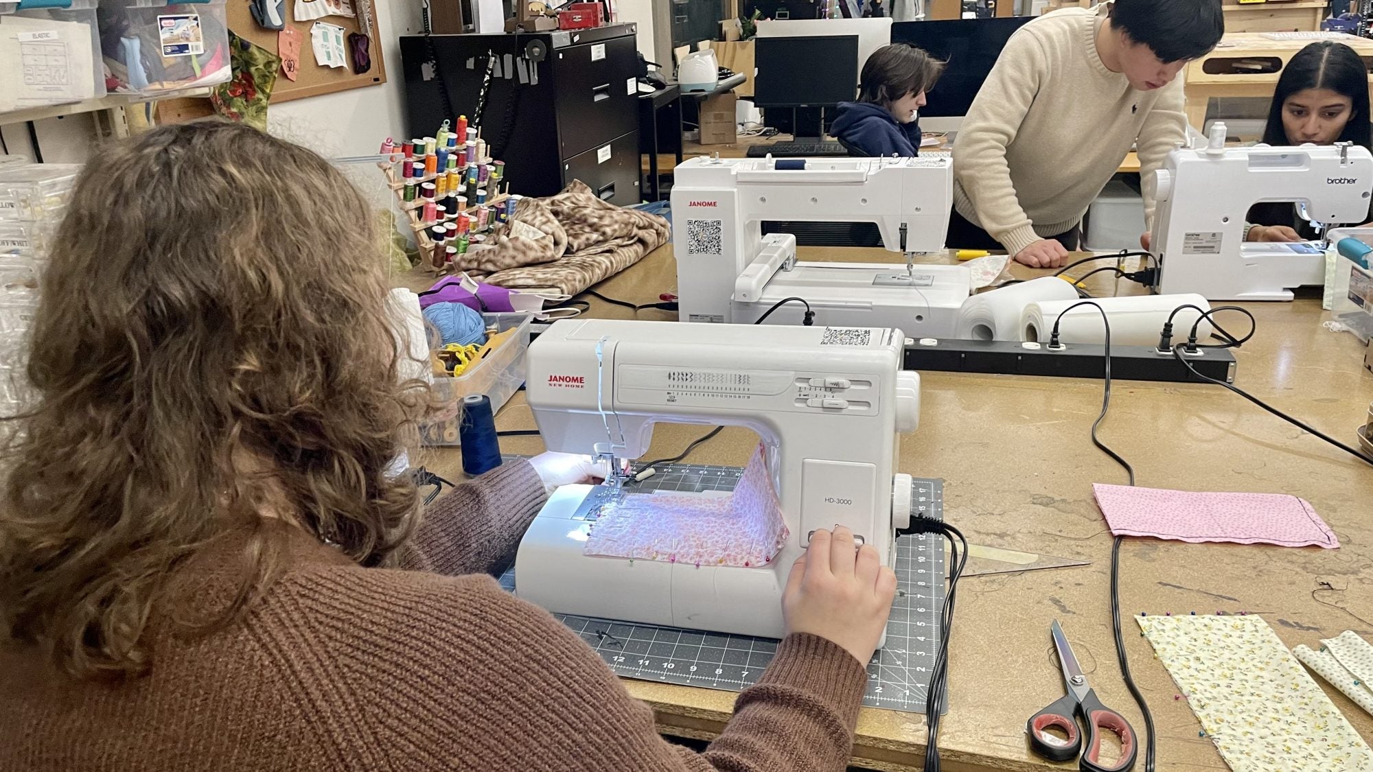 Students diligently sewing at the Makerhub