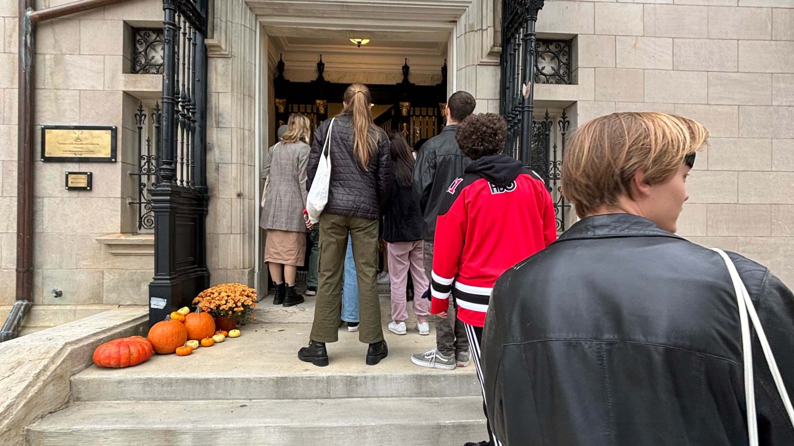 People line up outside an embassy for Halloween to Trick or Treat