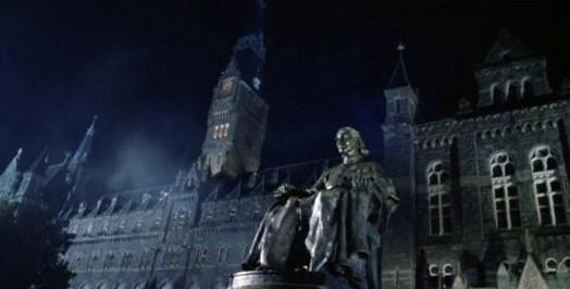 Photo of Healy Hall and John Carroll Statue on a dark, foggy night