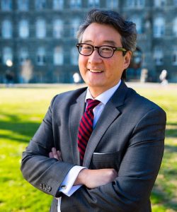 Portrait of Victor Cha with glasses in a suit and tie