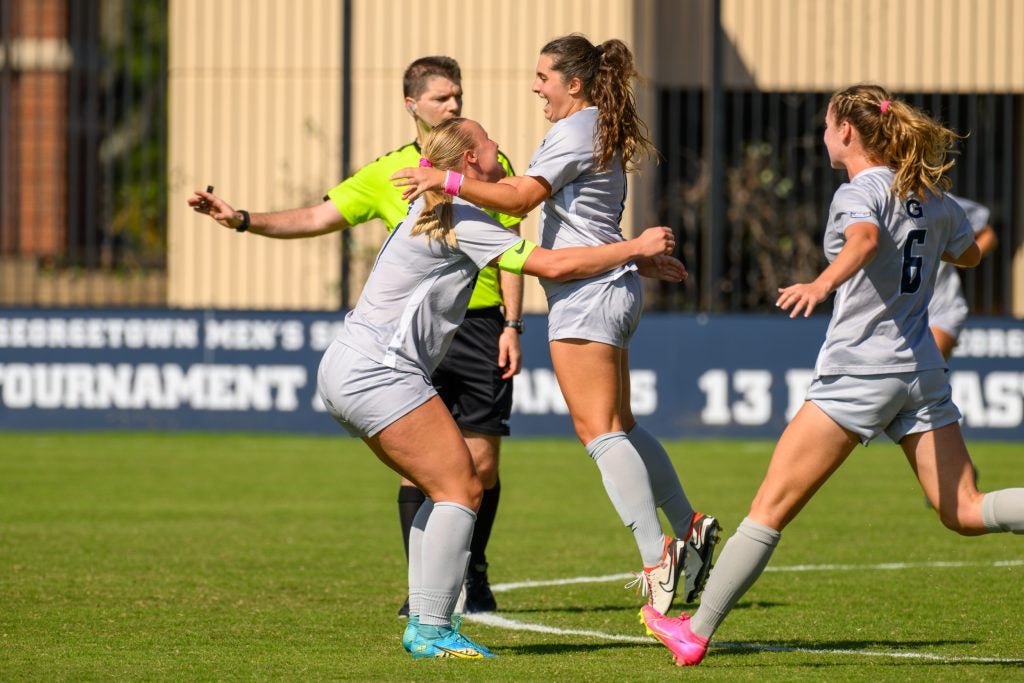 Women's soccer players celebrating