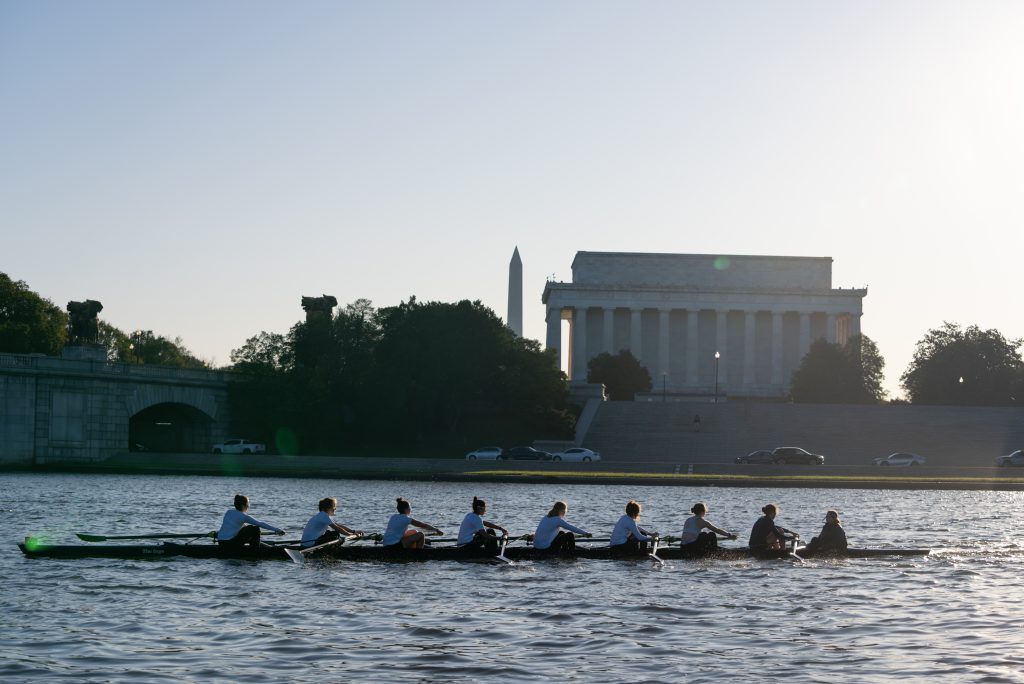 The rowing team rows past a monument in downtown Washington, DC.