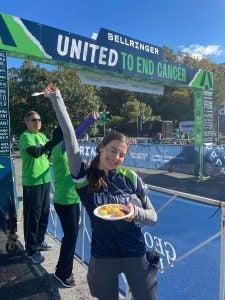 Ava poses with some food at the end of her bike ride