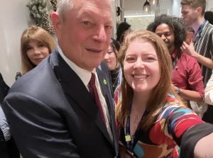 A young woman taking a selfie with Al Gore