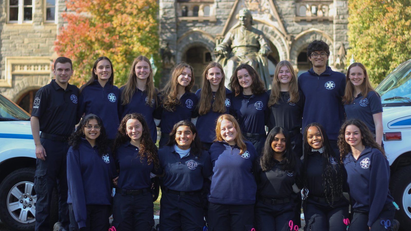 The volunteers for the student-run ambulance service, GERMS, pose together in front of Healy Hall in the fall.