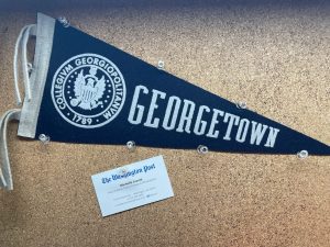 Georgetown pennant pinned on corkboard with a business card from Michelle Jaconi of The Washington Post