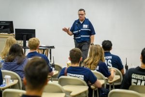 Man in an emergency uniform teaches a class