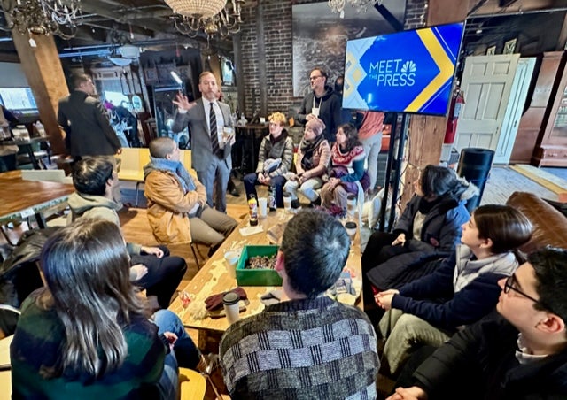 Chuck Todd meeting with GU students in a newsroom