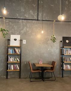 A rustic table between two book cases