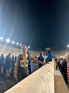 Young woman in running at night inside Olympic stadium in Athens.