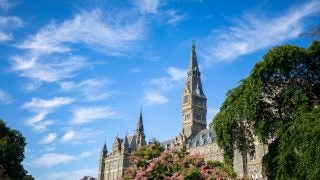 Healy Hall on a sunny day with flowers in bloom