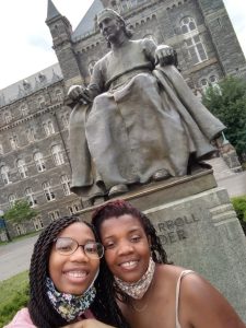 Christine and her mom pose for a selfie in front of the John Carroll Statue in Healy Circle