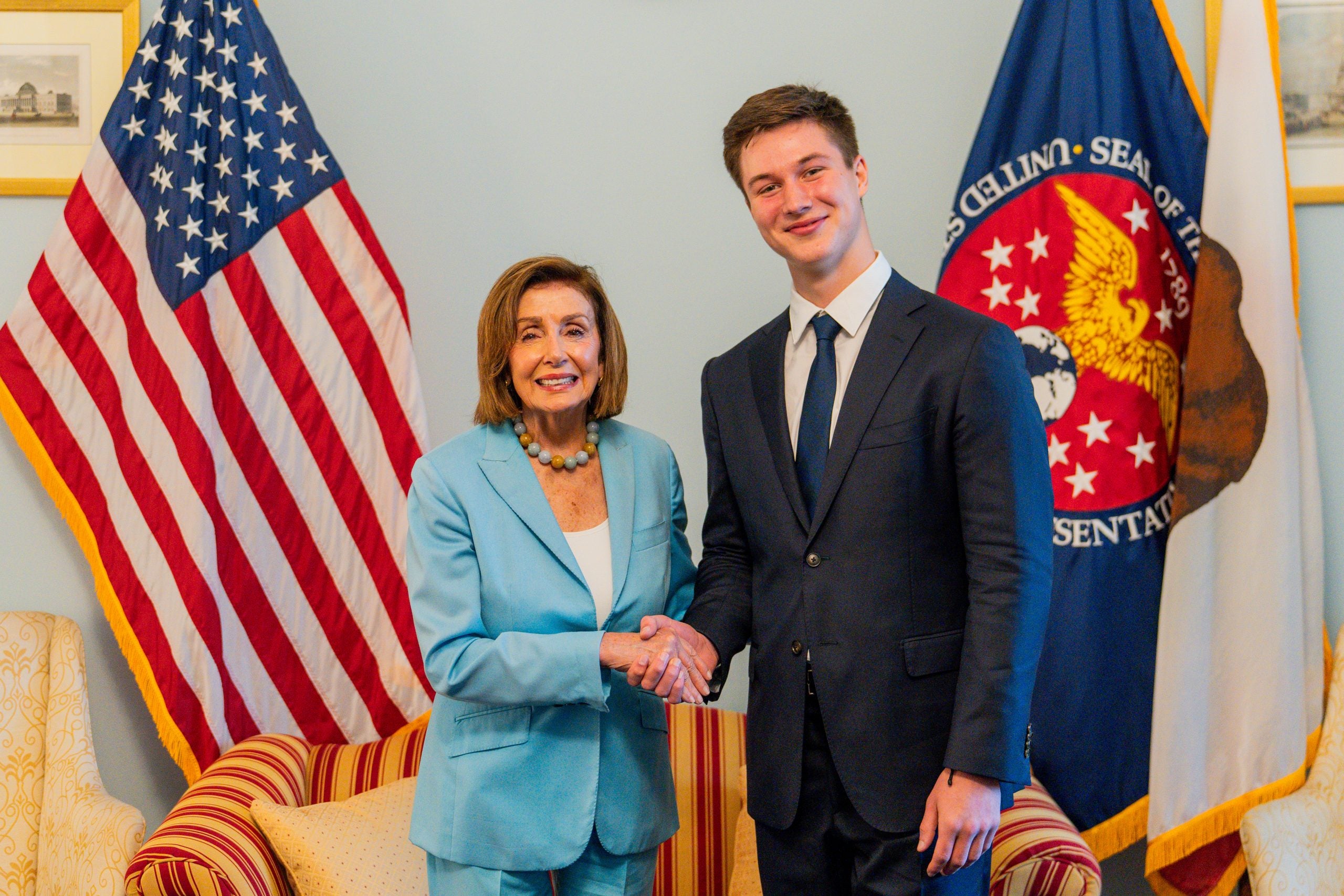 Kyryl Myronenko with Nancy Pelosi in front of a U.S. flag