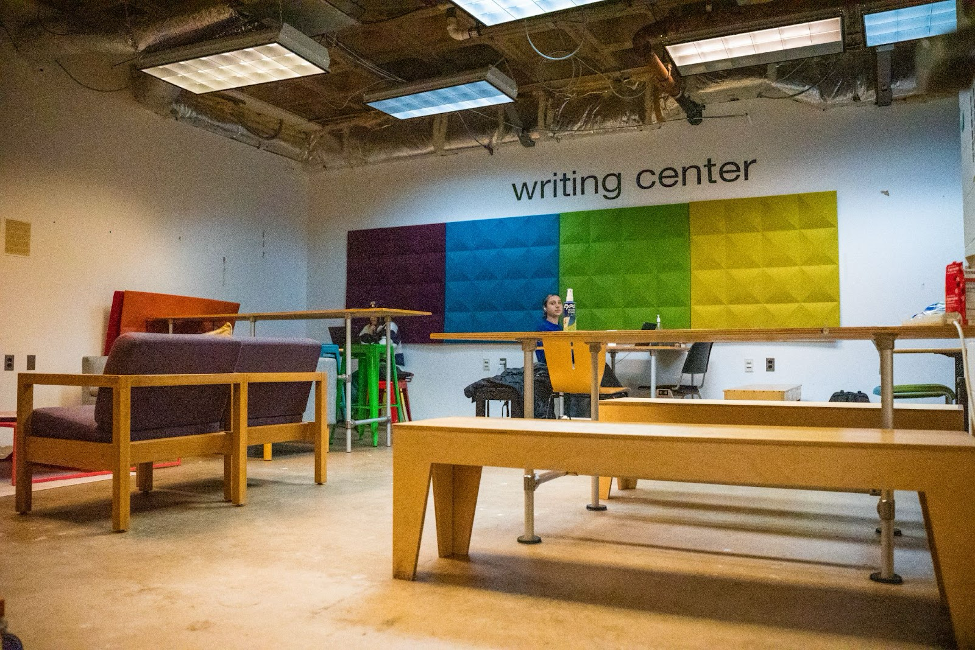 The Writing Center office space with tables and colorful art