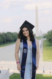 A young woman in graduation cap standing on the National Mall
