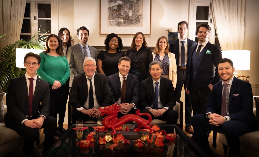 A group photo of people in formal attire at the Singaporean residence