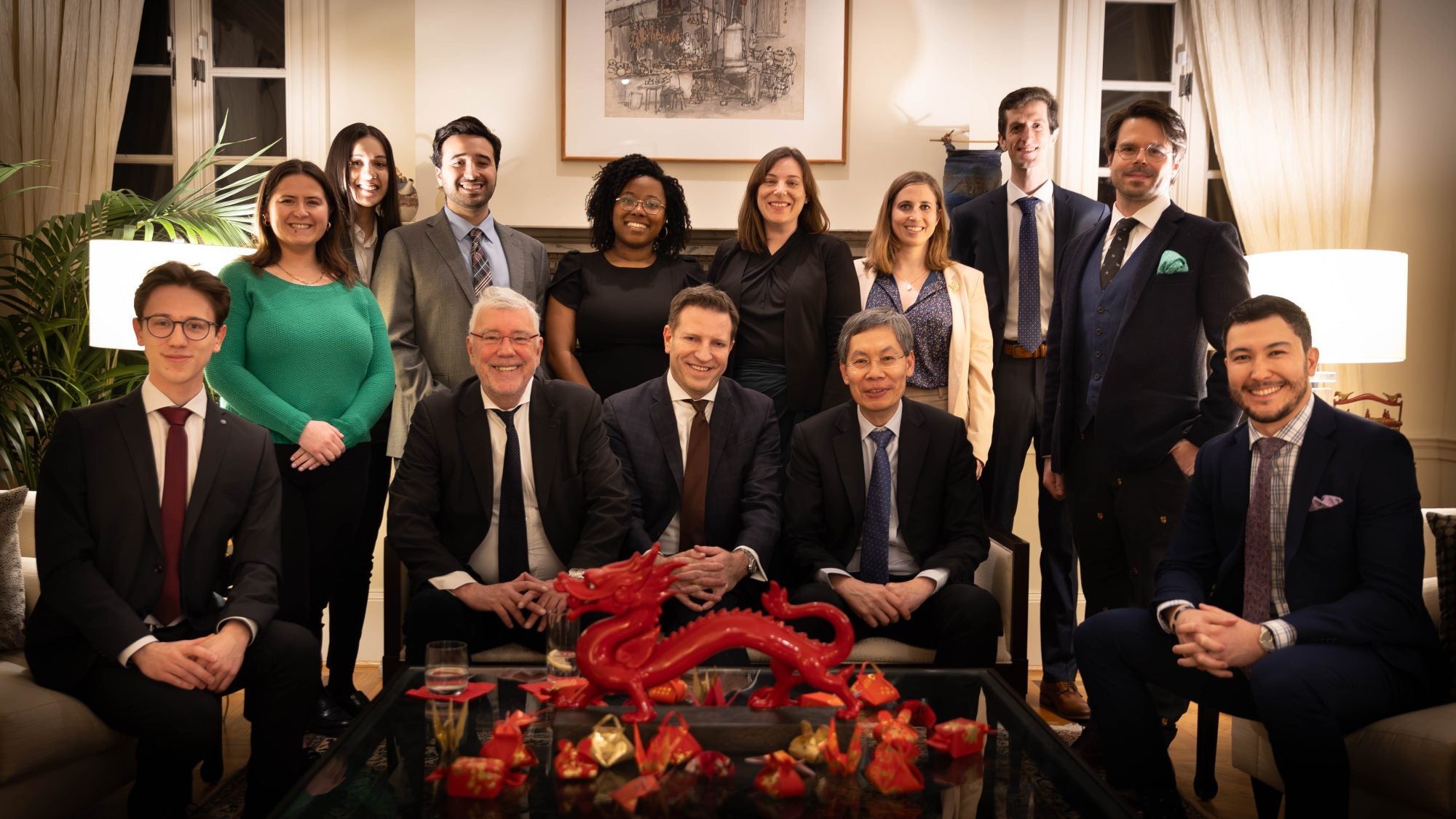 A group photo of people in formal attire at the Singaporean residence