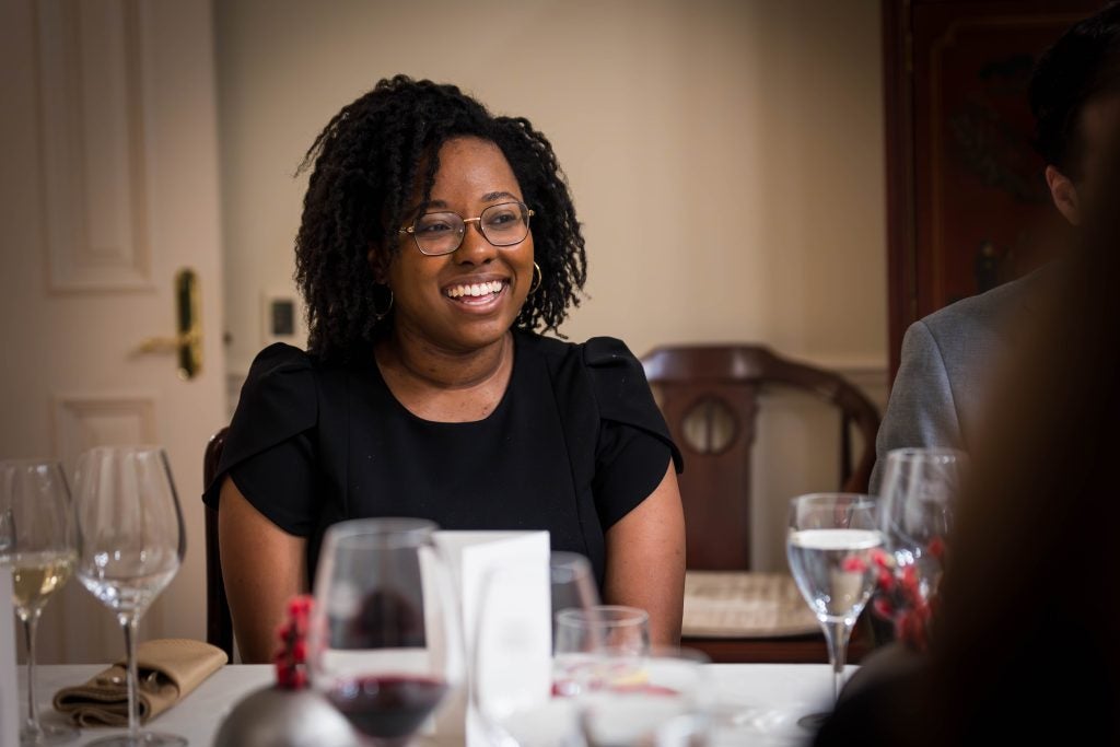 A woman smiling at a table