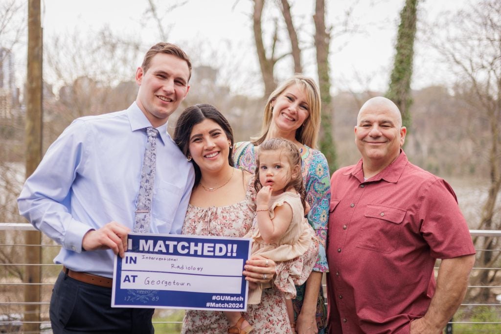 A family with a young daughter on match day