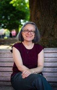 Lahra Smith on a park bench on a sunny day