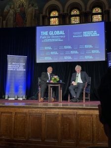 Boris Johnson sitting on stage at Gaston Hall for his discussion on democracy with GU Politics