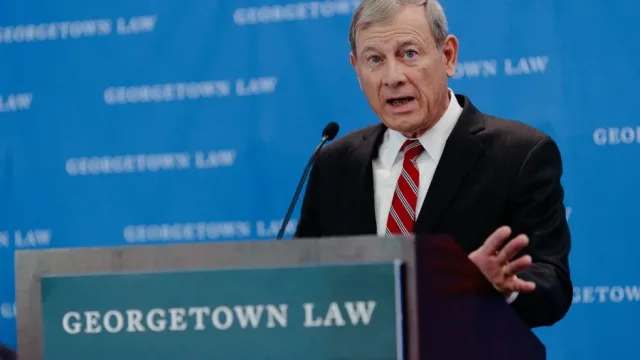 A Supreme Court Justice stands behind a podium that says &quot;Georgetown Law.&quot;
