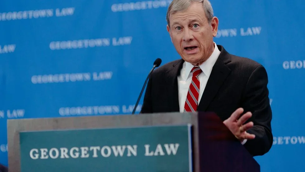A Supreme Court Justice stands behind a podium that says "Georgetown Law."