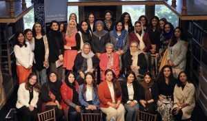 A group of Afghan women leaders gather together in a library at Georgetown.