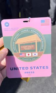 A pink press credential that says United States Press.