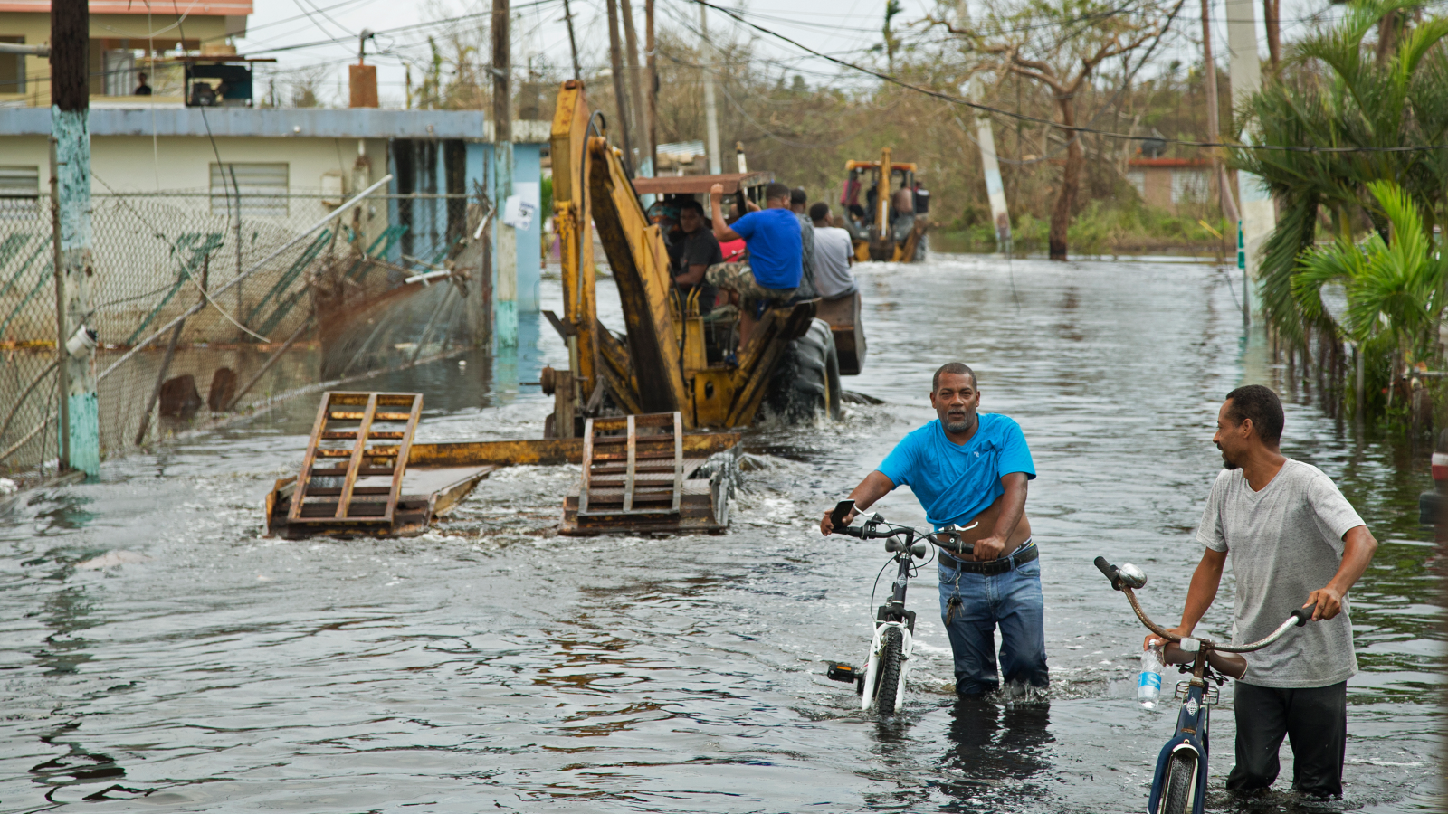 People stand in floodwater in the aftermath of Hurricane Maria in Puerto Rico in 2017.