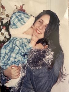 A mother and her daughter embrace in a photo from the early 2000s.