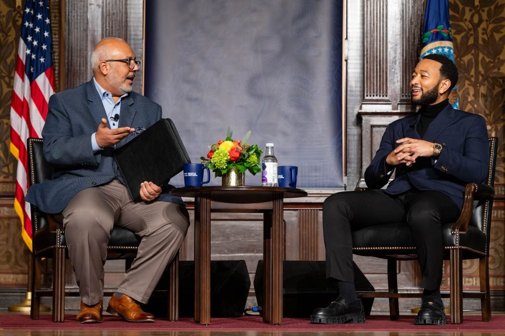 Legend speaking with Elleithee on stage in Gaston Hall