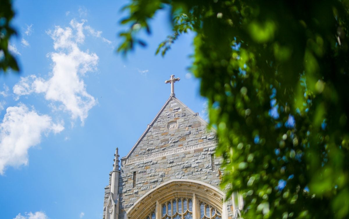 A view of a cross on a stone building on a sunny day at Georgetown.