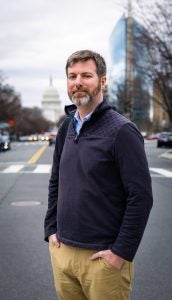 Kennedy on a street with the US Capitol in the background