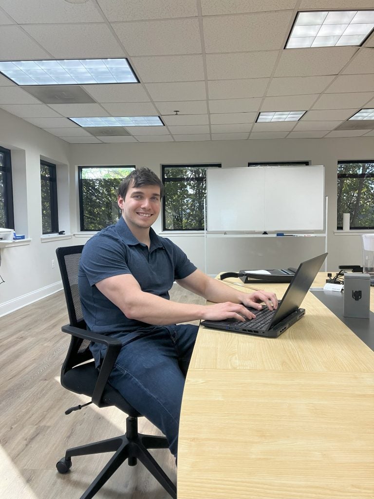 John Andrzejewski on his laptop in an office