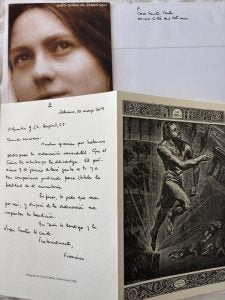 A handwritten letter from Pope Francis with Jesus on the front of the card