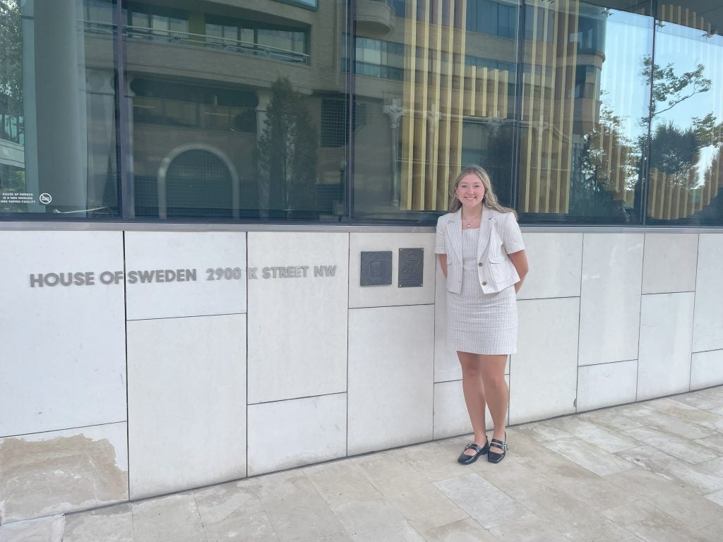 Young woman in business attire outside of the Swedish Embassy
