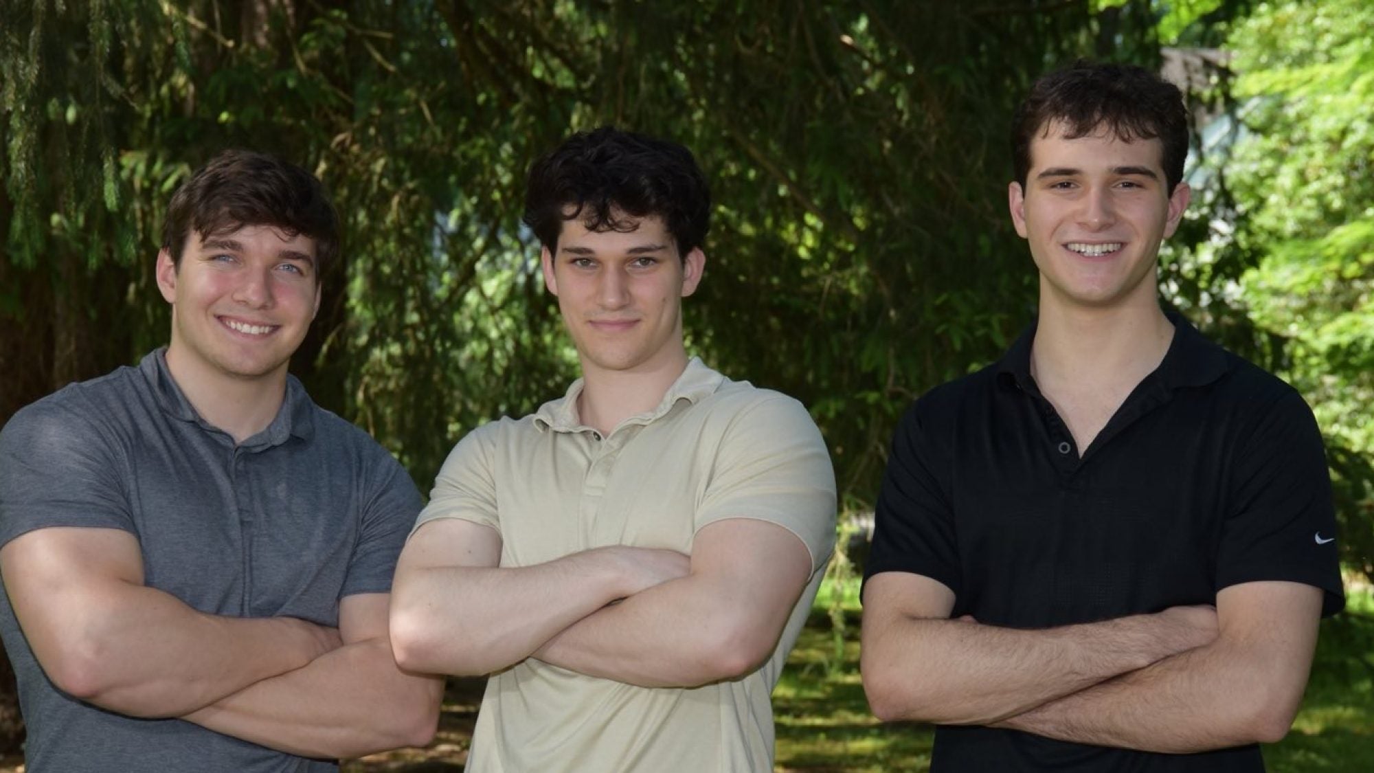 John Andrzejewski (C&#039;25), Eli Kerstein (C&#039;24) and Lucas Raskin wearing polo shirts and smiling at the camera