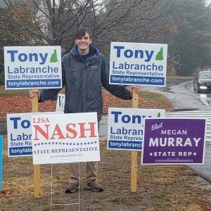 Tony with campaign signs outside