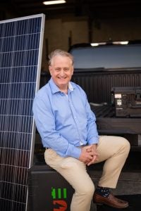Shmotolokha sitting with a solar panel and portable power unit