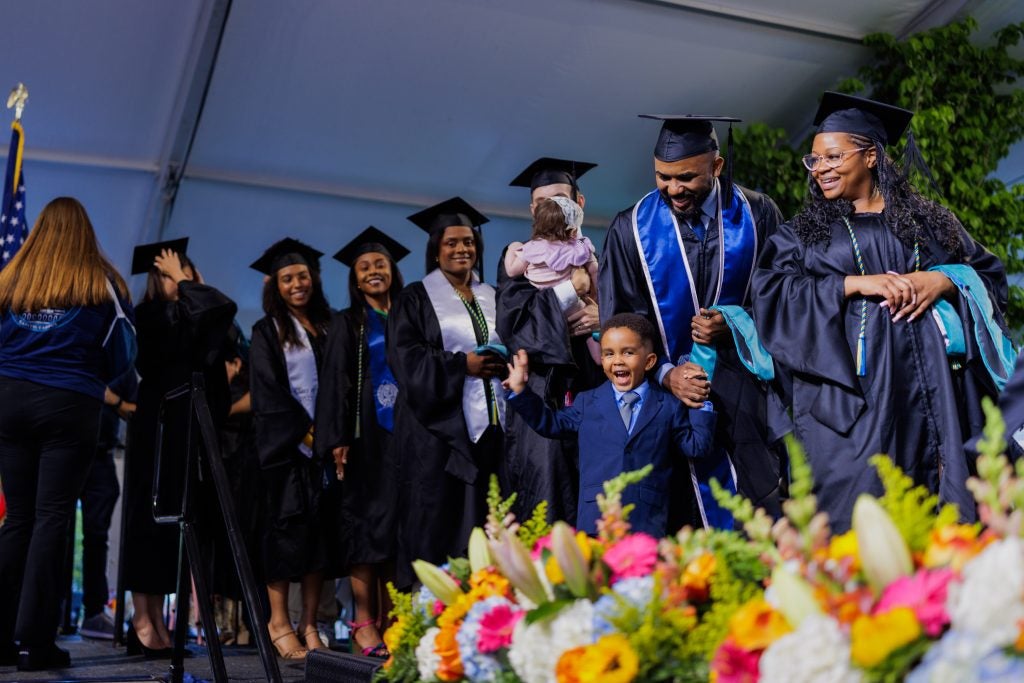 Young child with his father at graduation