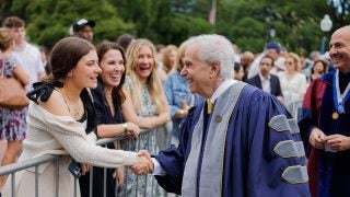 Henry Winkler greets a crowd as he walks into Georgetown's graduation