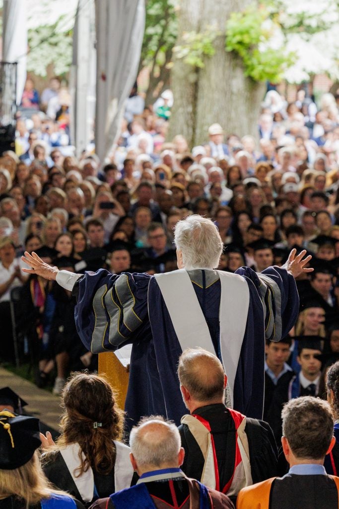 Henry Winkler holds out his arms to a crowd of graduating students