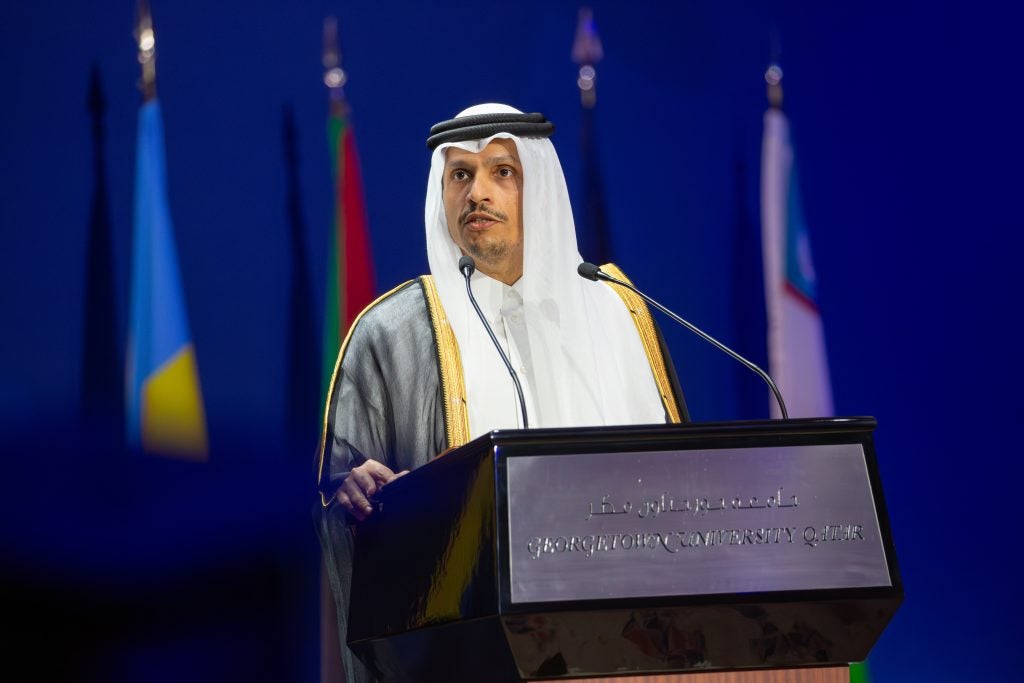 The prime minister of Qatar speaks behind a podium