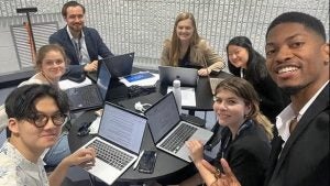 Wibowo at a table with other young people with laptops out