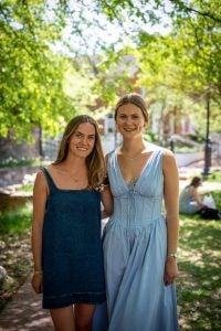 Mia Foster and Emma Pernebo is blue dresses posing for a photo together