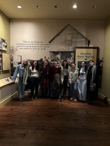 Students in a dimly lit museum