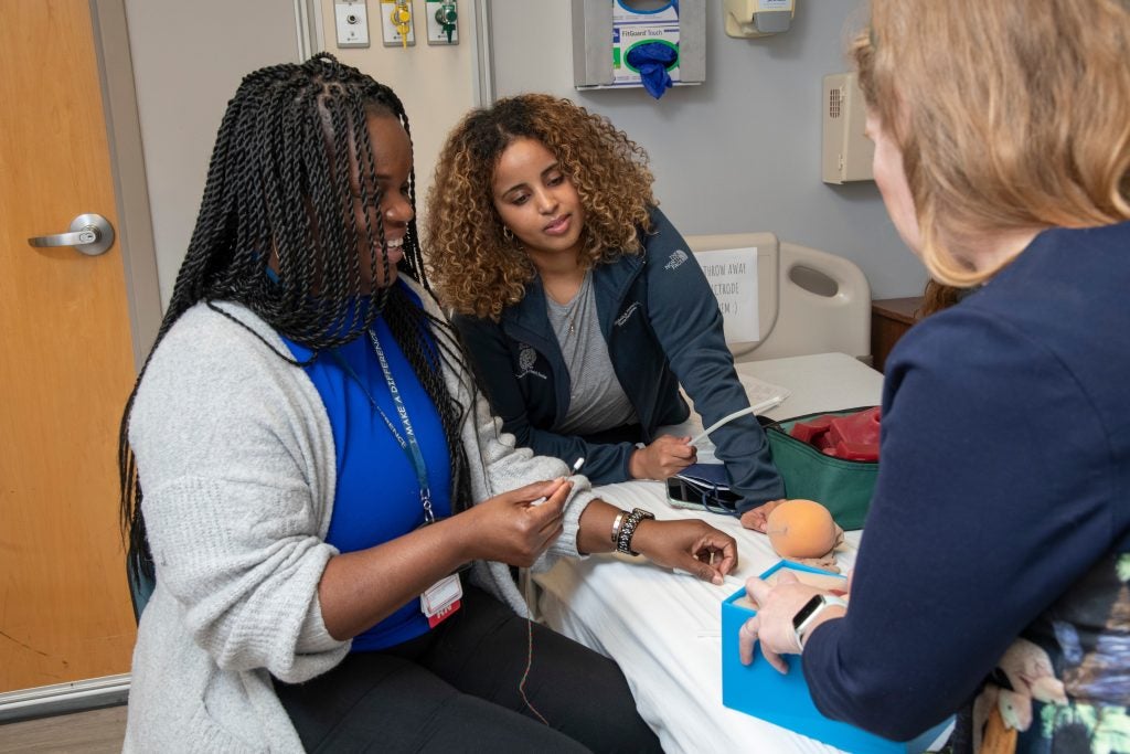 Nursing students practice in a clinical setting